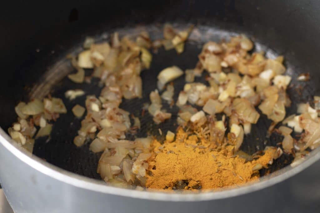 cooked onions in pan with turmeric
