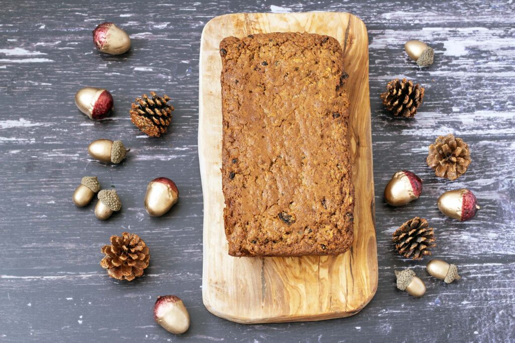 Christmas carrot cake tea loaf on board with xmas table decorations