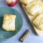 apple turnovers on board and green plate