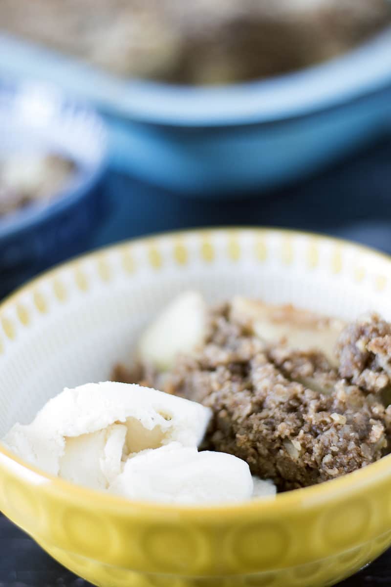 close up of apple crumble and ice cream in bowls