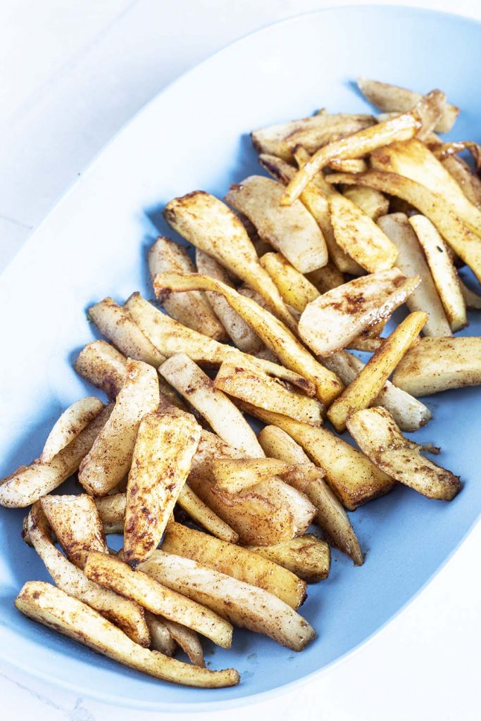 roasted parsnip and turnip wedges on blue platter