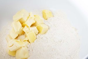butter and flour in white bowl for crumble topping