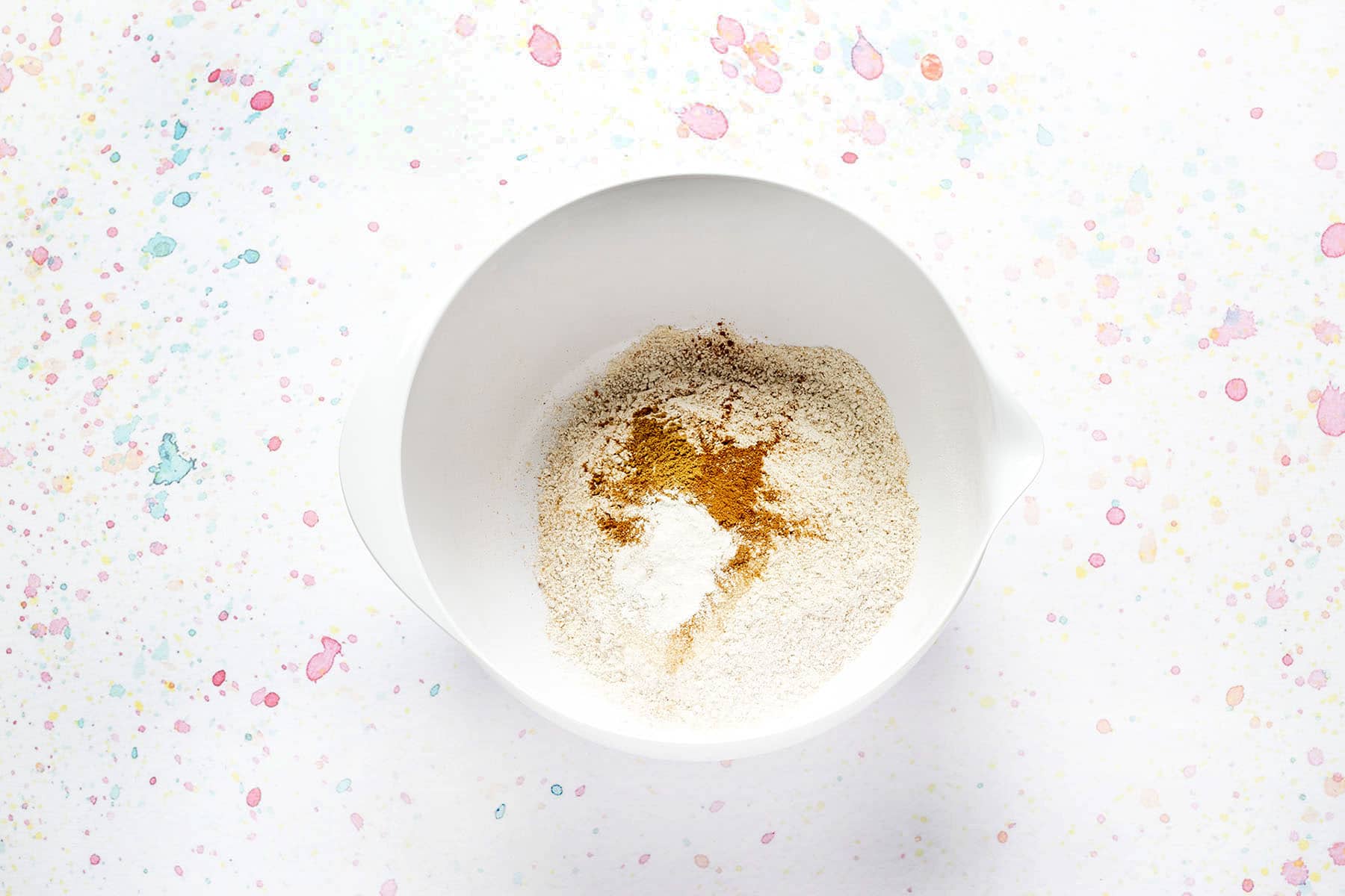 flour, spices and baking powder in white bowl