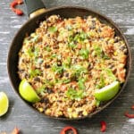 mexican rice with limes and coriander in pan