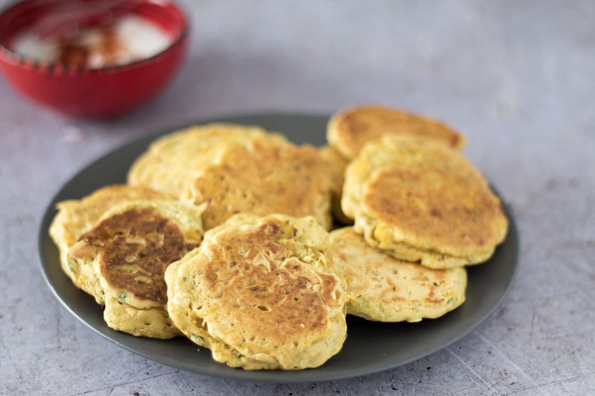 indian spiced sweetcorn fritters on grey plate