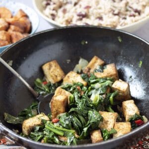 vegan caribbean recipes jerk tofu and callaloo or spinach with rice and beans and sweet potatoes