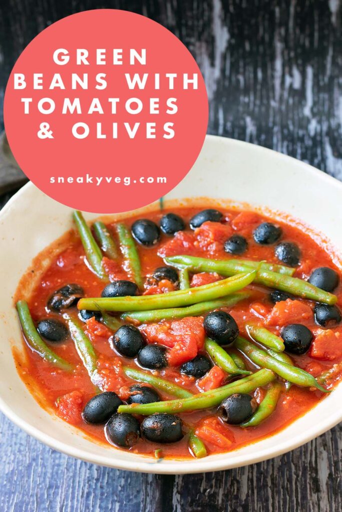 green beans in ceramic bowl with tomato sauce and olives
