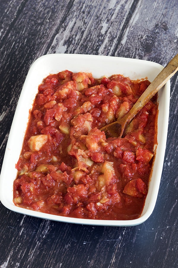 easy patatas bravas in dish with wooden spoon