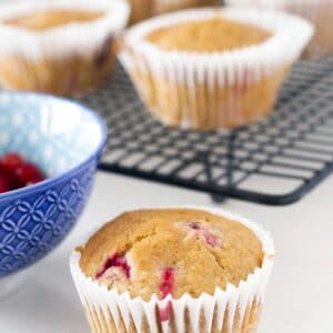 redcurrant muffins on cooling rack with bowl of redcurrants
