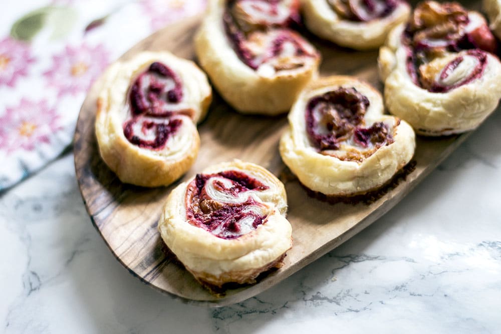 savoury palmiers with beetroot and goat's cheese on wooden plate