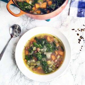 borlotti bean and spinach soup in white bowl