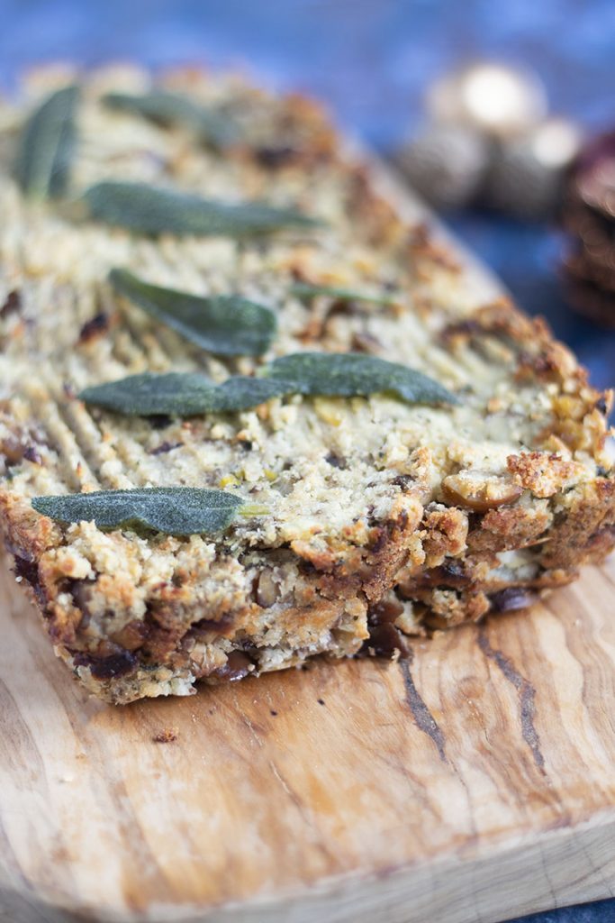 Parsnip and chestnut nut roast on board with sage leaves