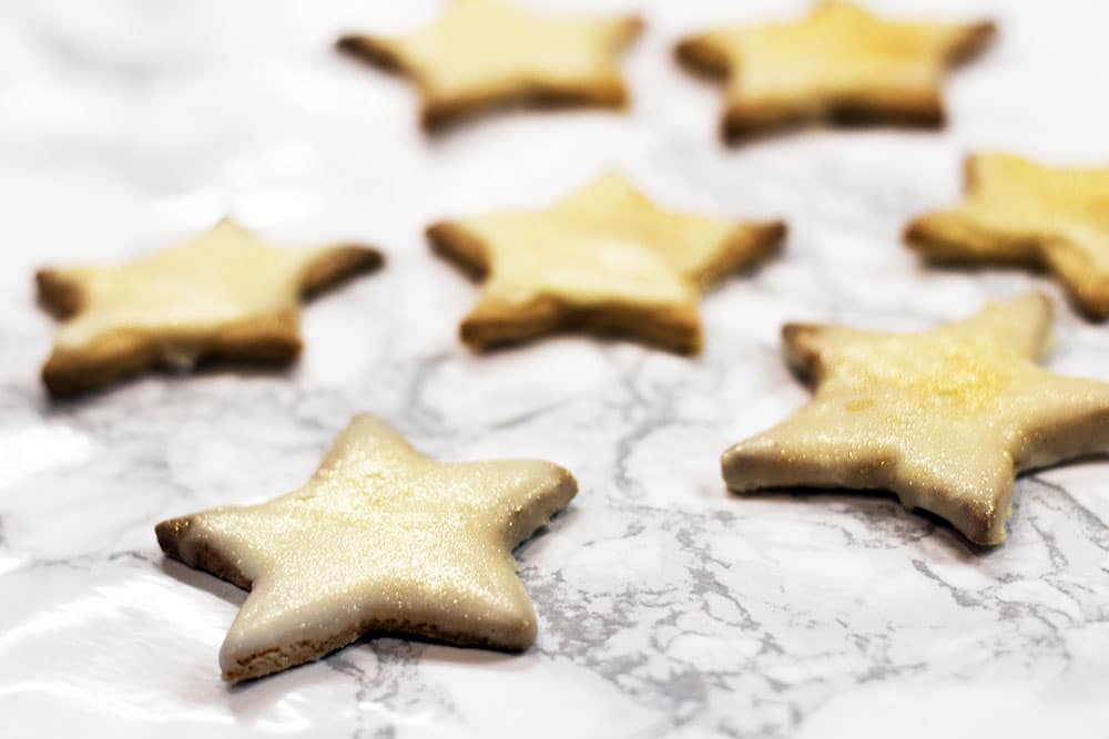 gingerbread stars on white marble background
