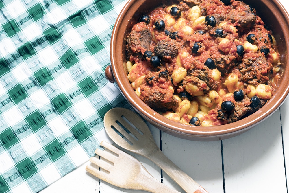 vegetarian meatballs made with aubergine in dish with gnocchi and olives