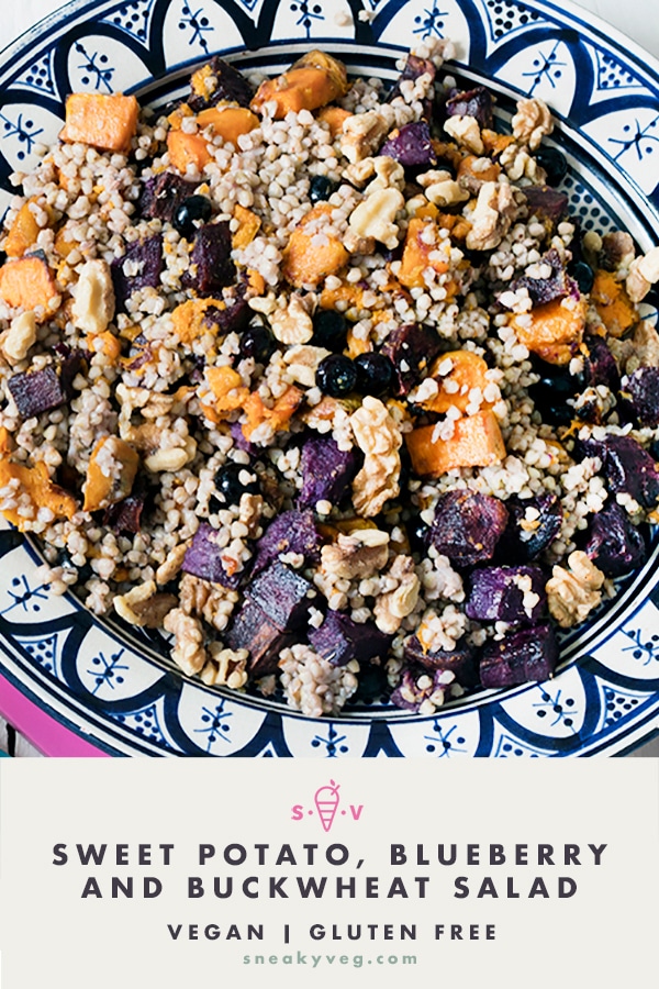 Buckwheat salad in bowl with purple and orange sweet potatoes and blueberries