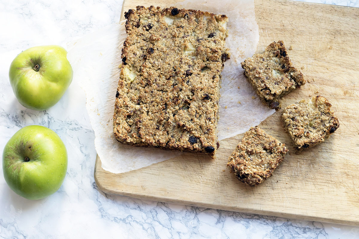 refined sugar free flapjacks on board with two cooking apples