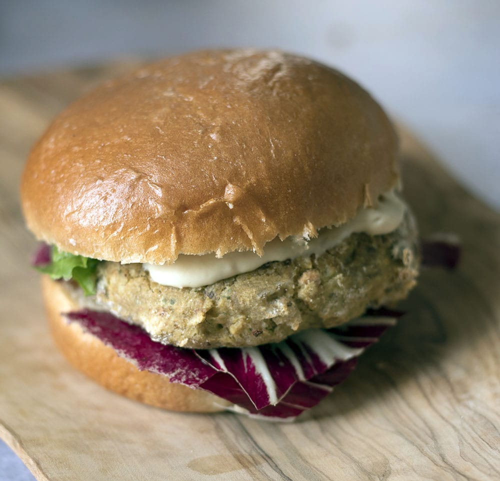 chickpea and sweetcorn burger in bun with salad