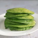 green pancakes made with spinach on white plate