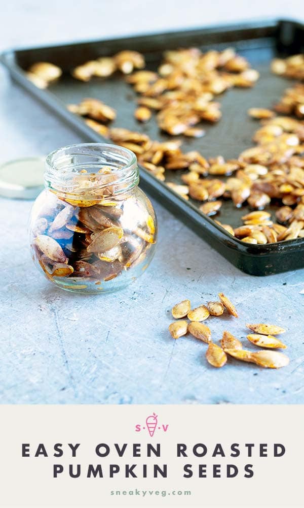 pumpkin seeds in glass year with baking tray in background