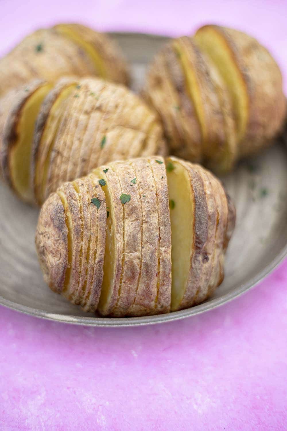 four hasselback potatoes on plate