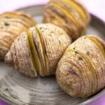 four hasselback potatoes on plate