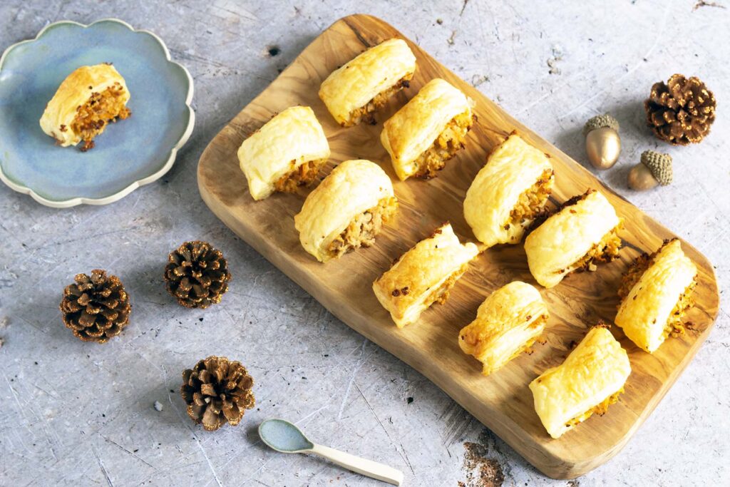 vegetarian sausage rolls on wooden board and blue plate