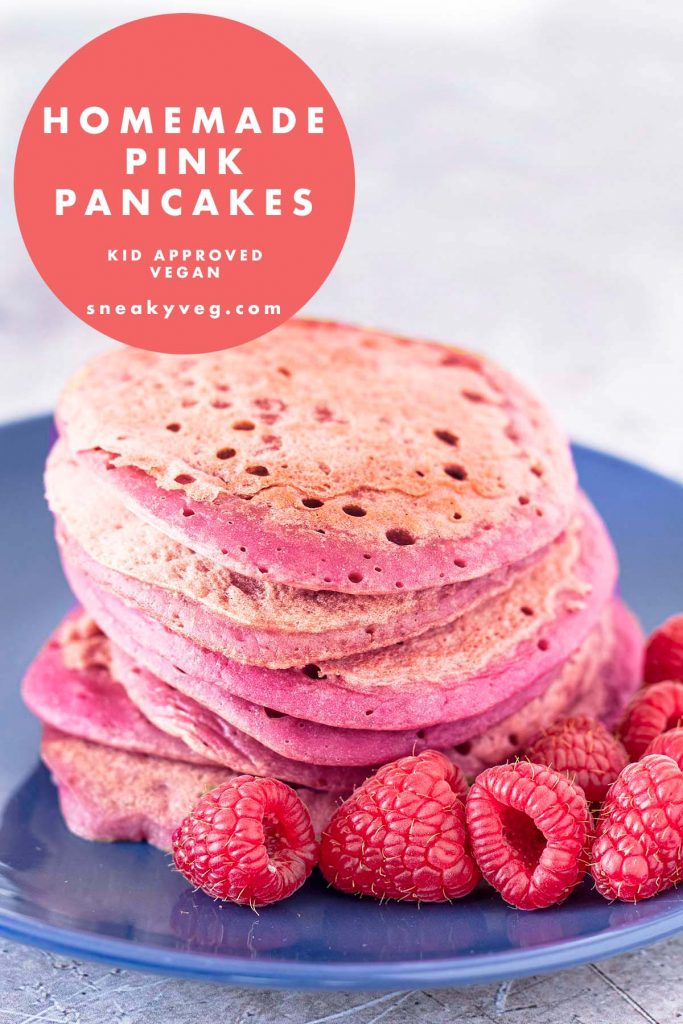 stack of pink pancakes with raspberries