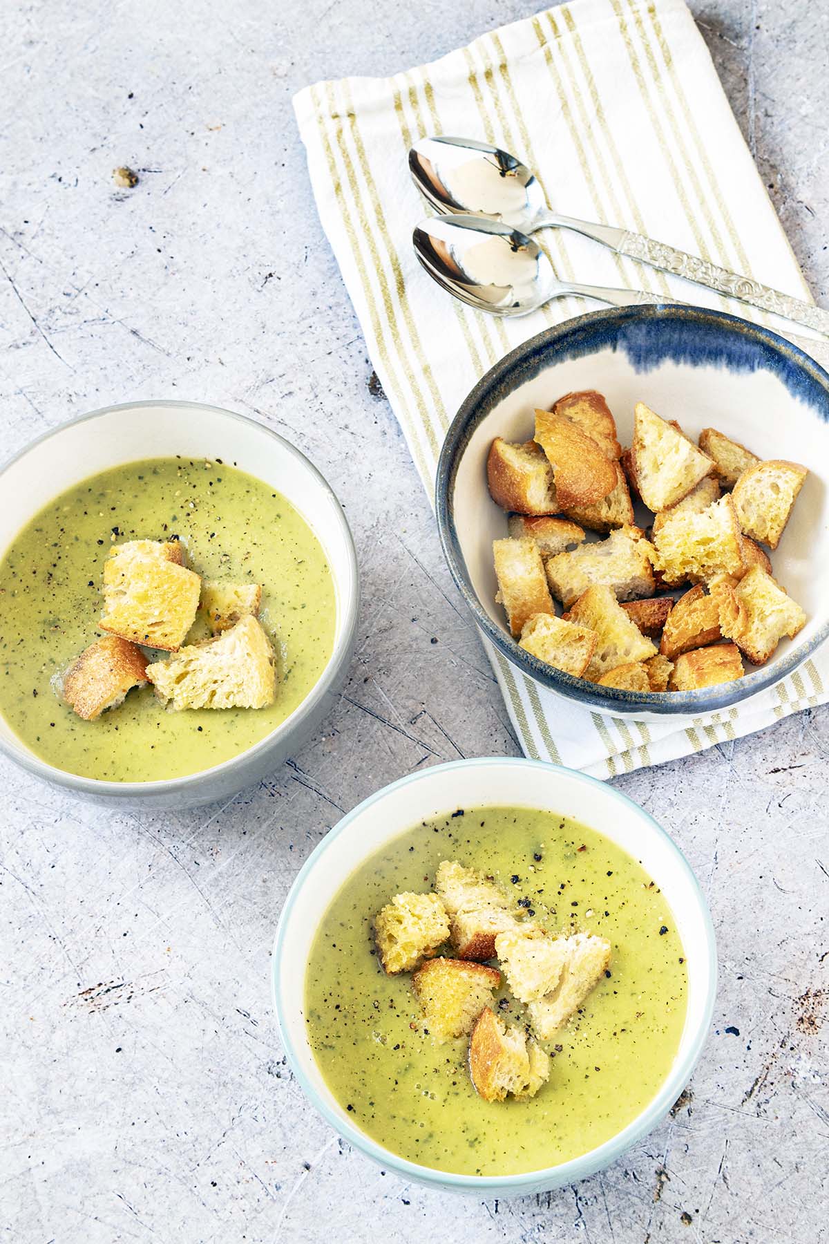 Potato and courgette (zucchini) soup in bowl with croutons