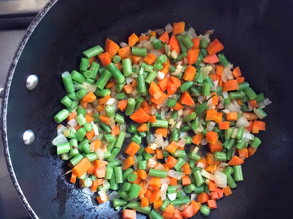 how to make veggie fried rice - stir fried veggies in wok