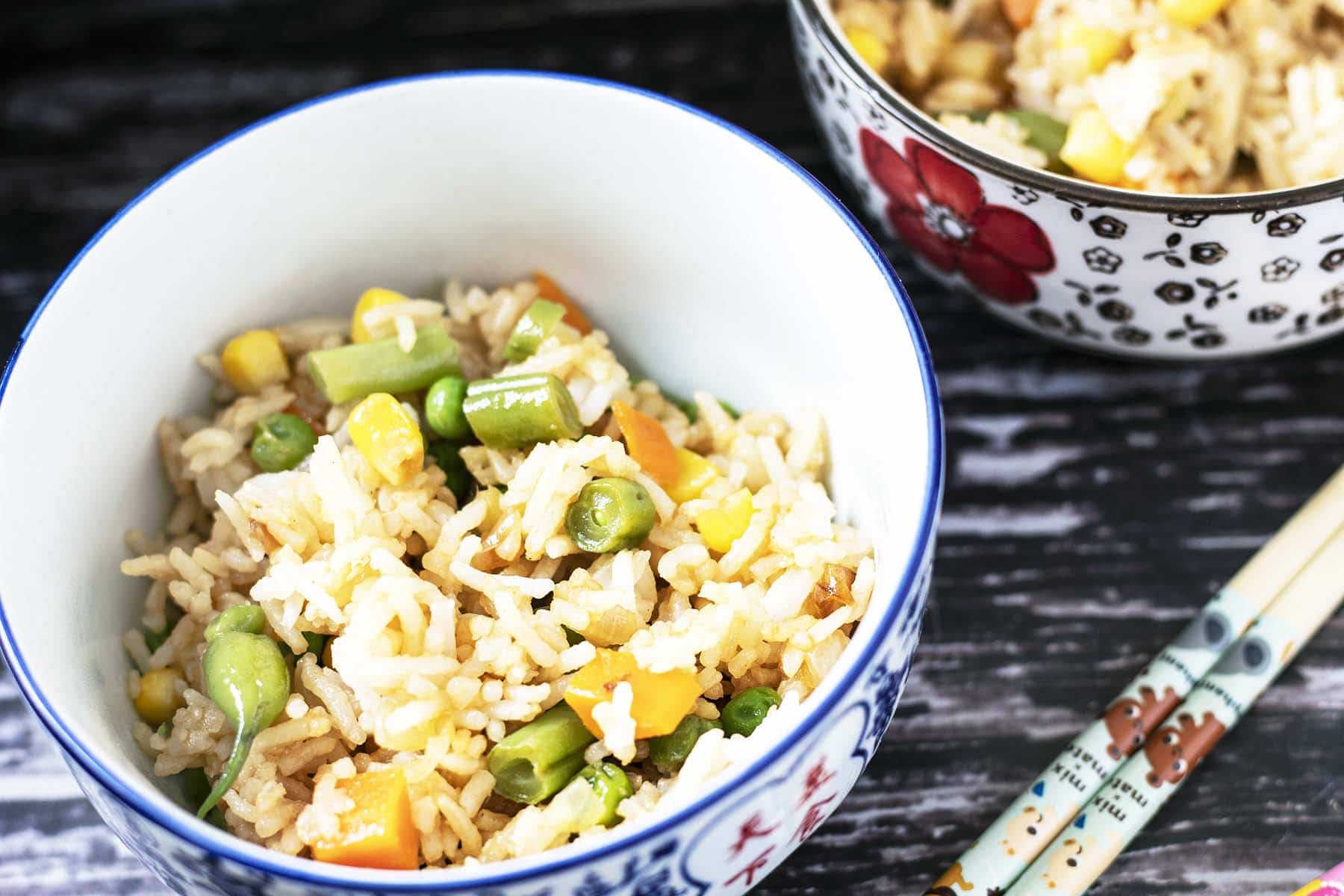 veggie fried rice in bowls with chopsticks
