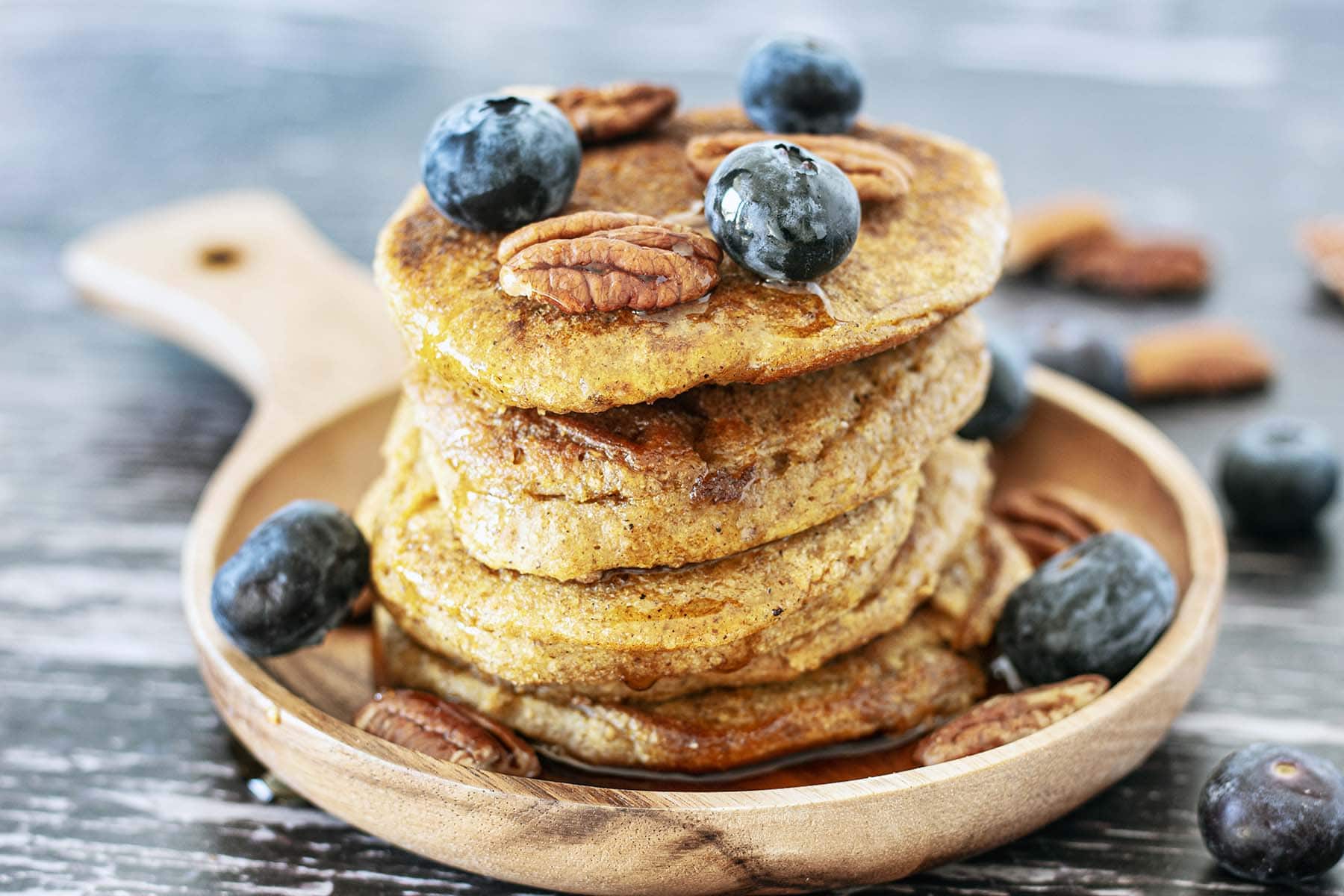 stack of butternut squash pancakes with pecans and blueberries