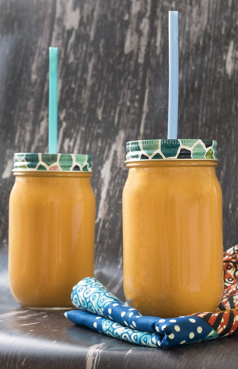 carrot smoothie in two smoothie jars