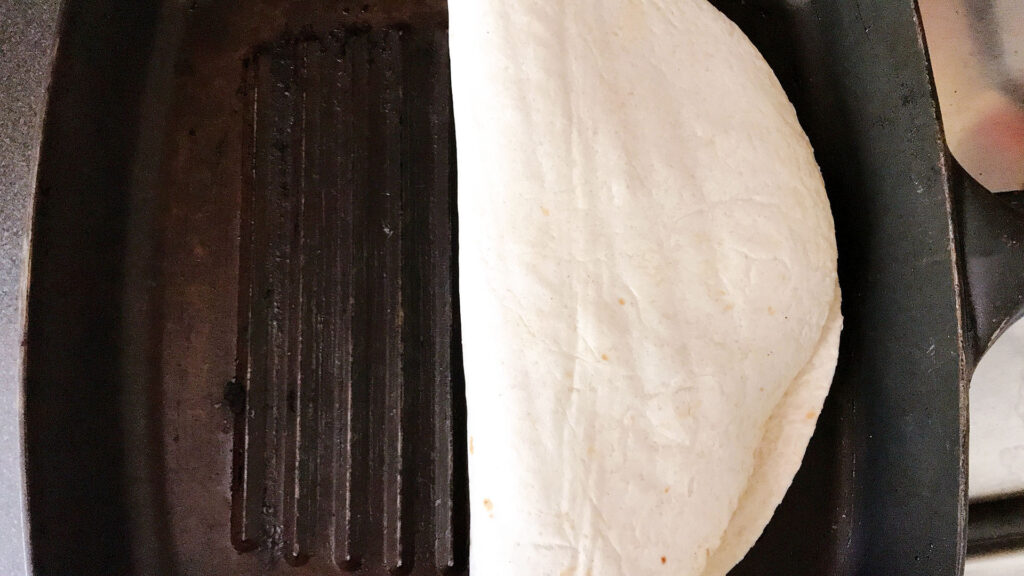 Folded quesadilla on griddle pan