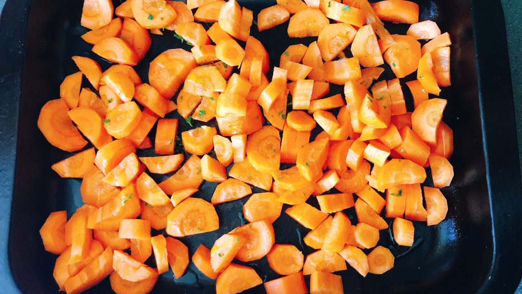chopped carrots in roasting tin