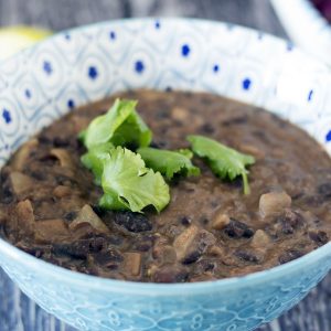 refried black beans in blue and white bowl