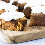 small carrot loaf cakes on wooden board with frosting
