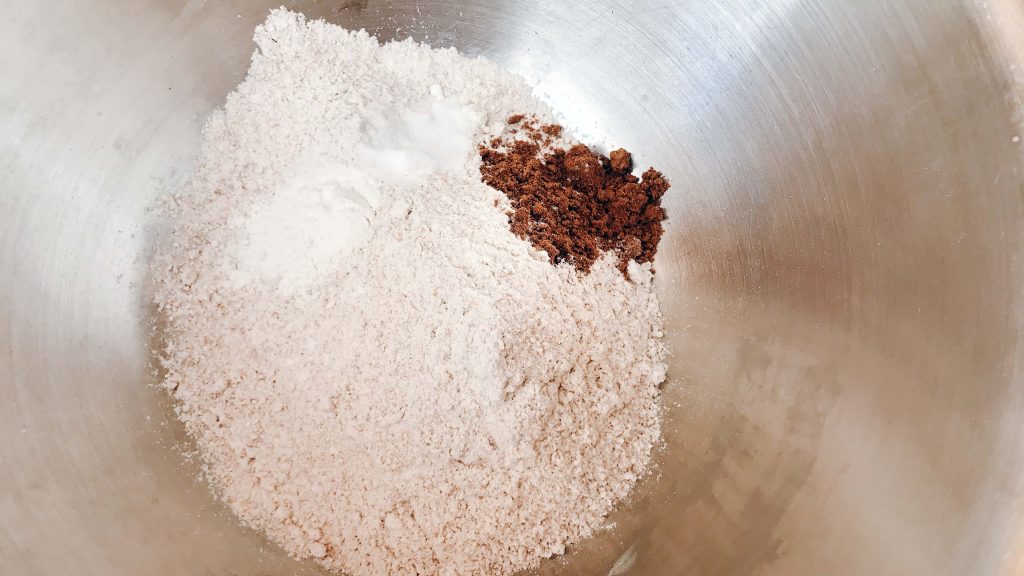 flour with mixed spice and baking powder in a mixing bowl