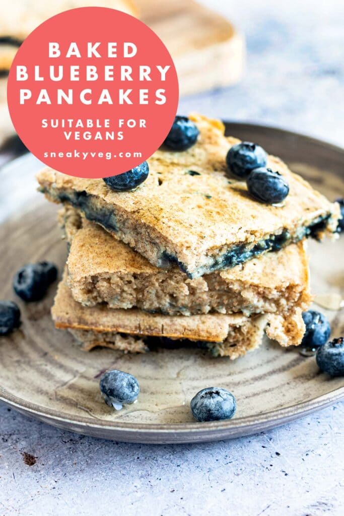 oven baked blueberry pancakes stacked on plate with blueberries