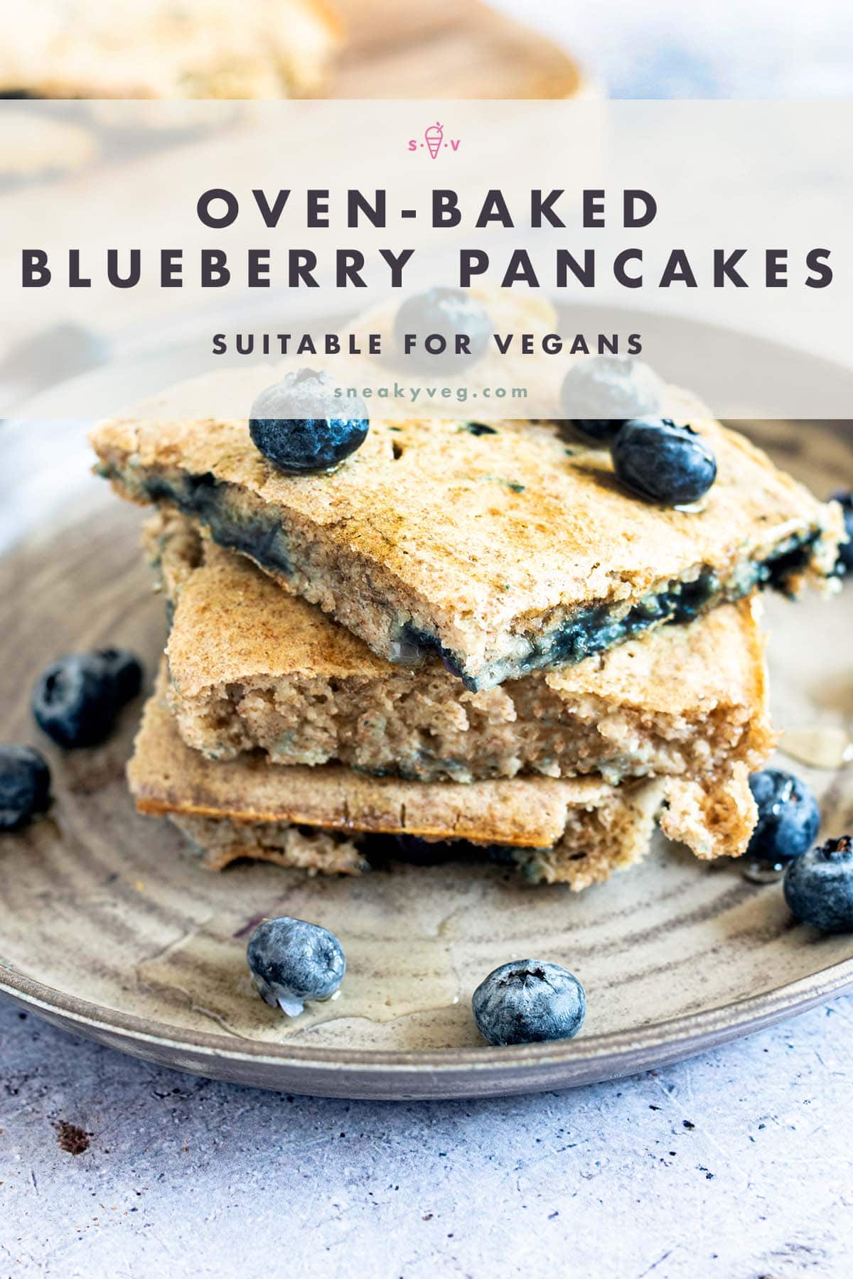 oven baked blueberry pancakes stacked on plate with blueberries