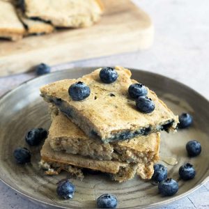 baked pancakes on ceramic plate with blueberries