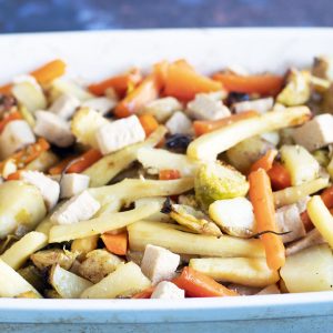 blue and white roasting dish with christmas vegetables