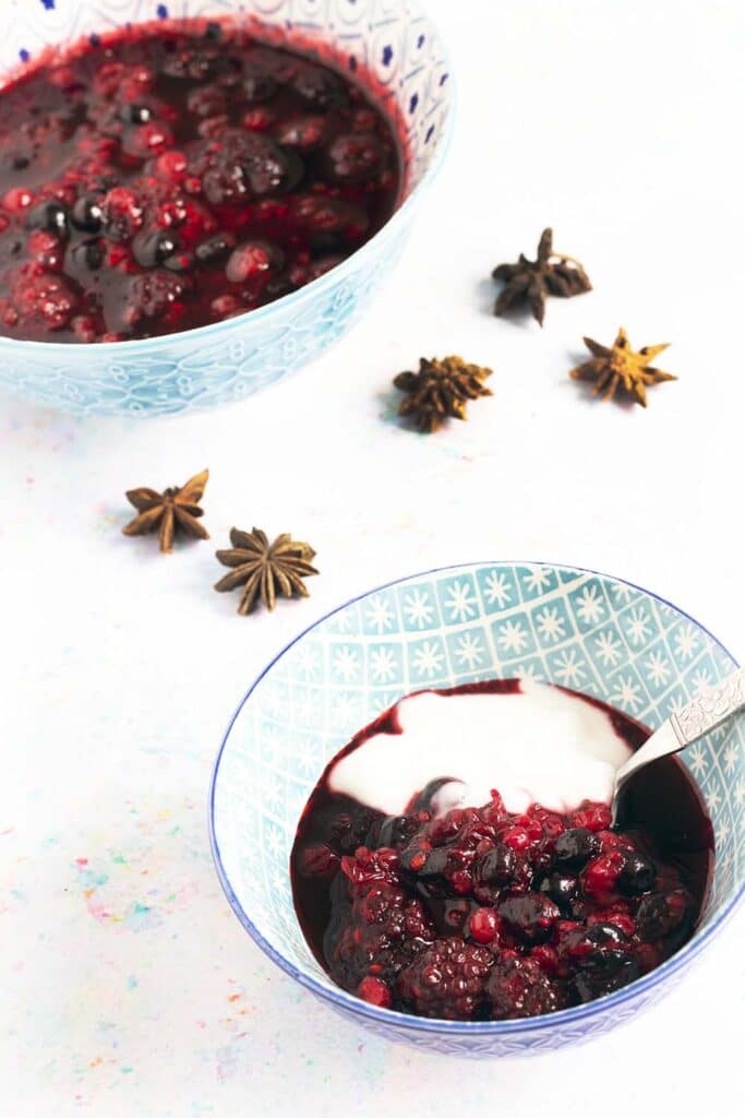 bowls of berry compote and yoghurt with star anise