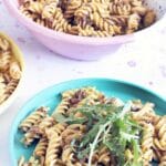 sundried tomato pasta pesto topped with rocket on colourful plates