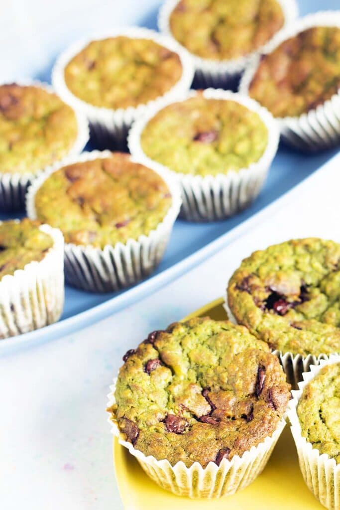 spinach and banana muffins on yellow plate and blue tray