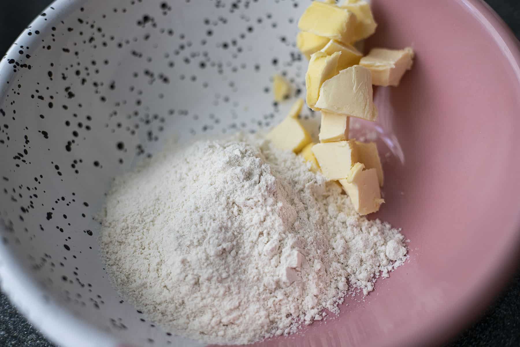 flour and butter in pink and white bowl