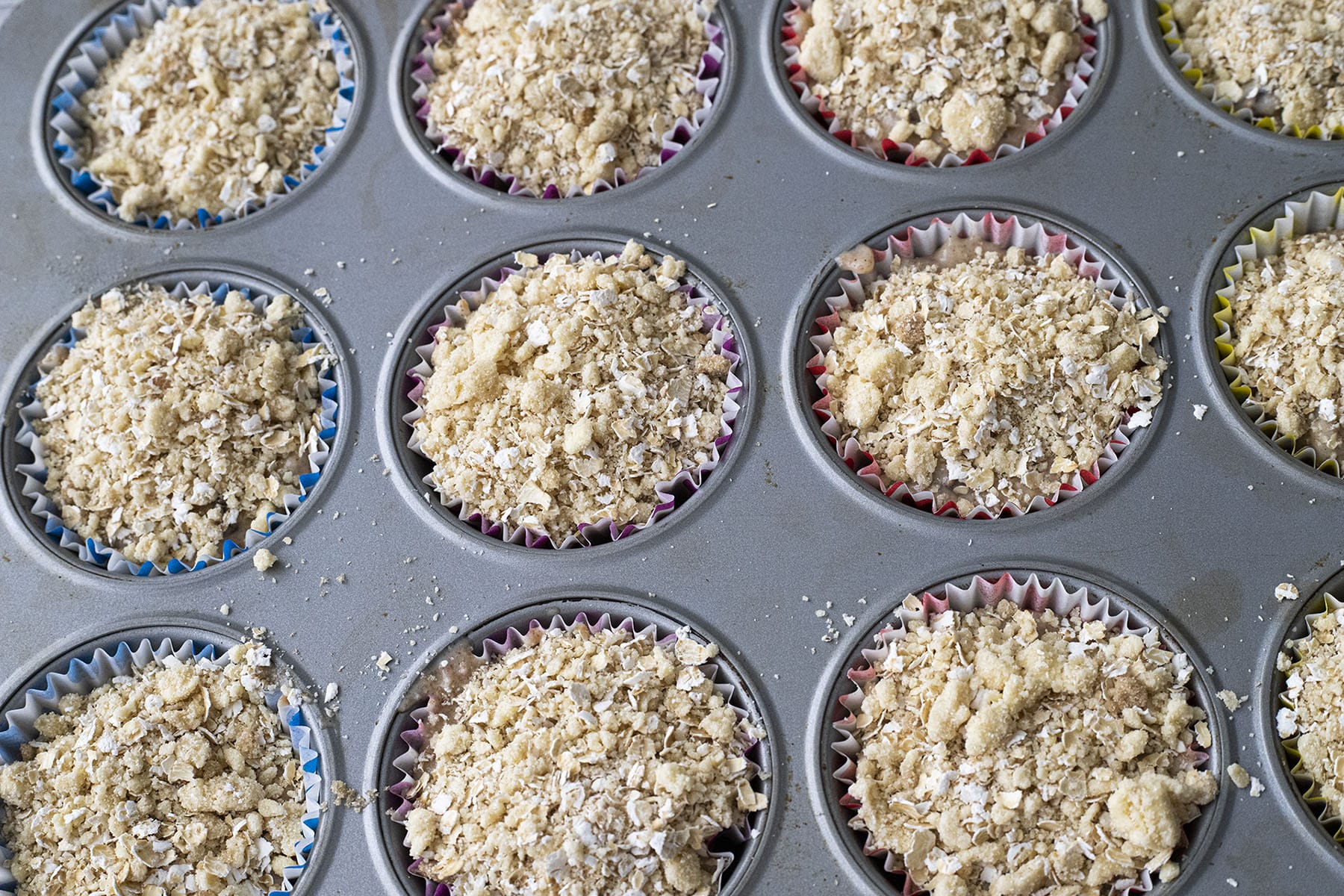 pear muffins in muffin tin before baking