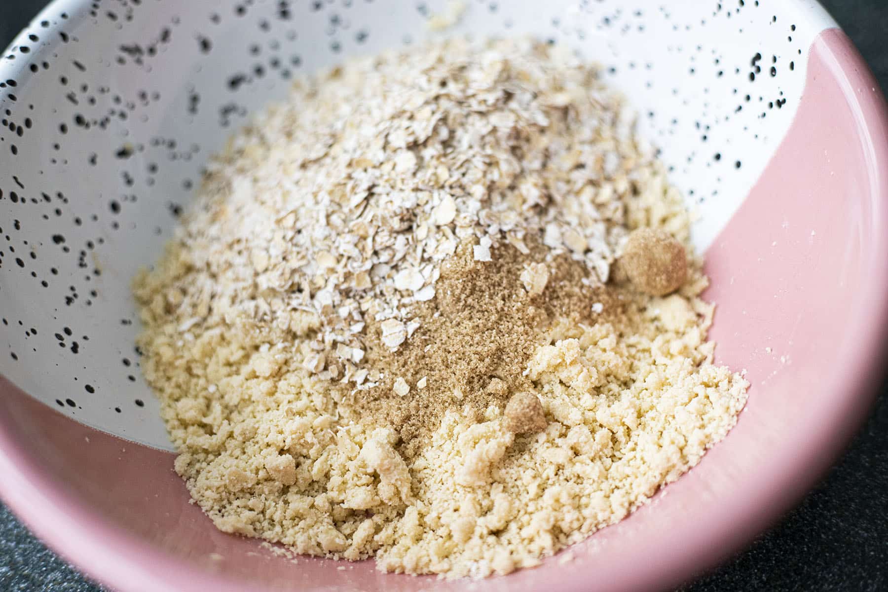 butter, sugar, oats and flour in pink and white bowl