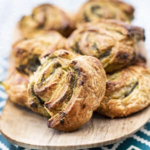 spiced savoury puff pastry rolls on a wooden platter
