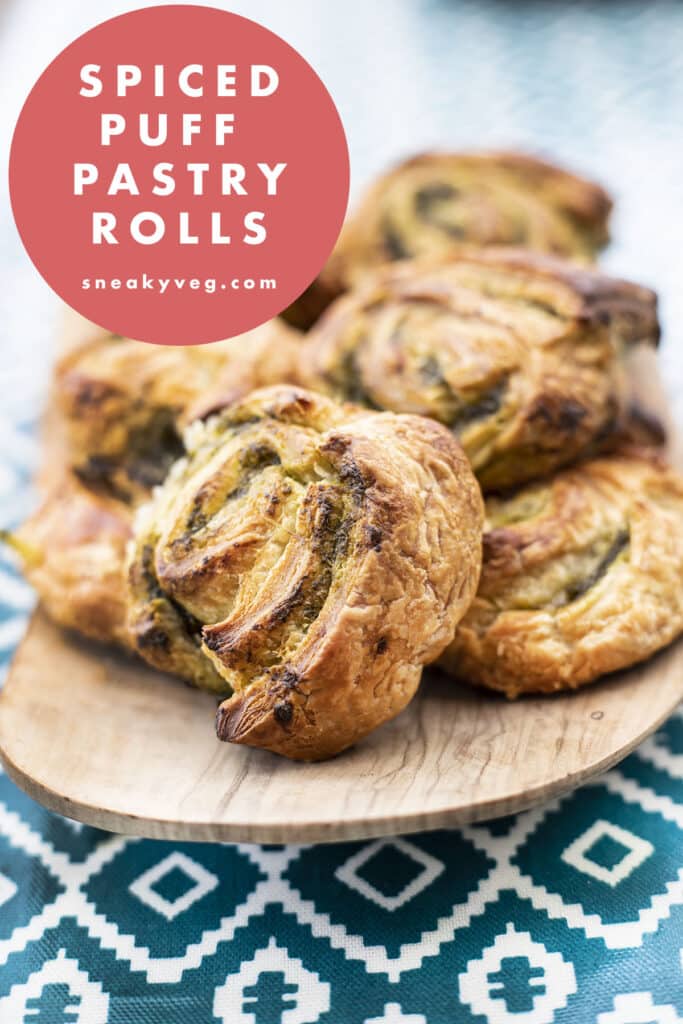 spiced savoury puff pastry rolls on a wooden platter
